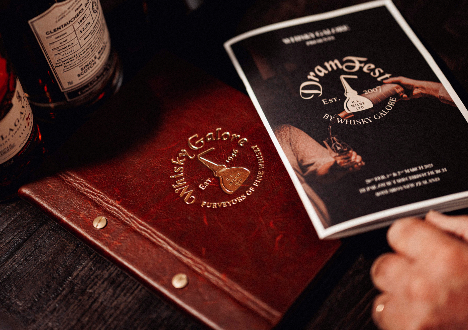 An image of a DramFest bookflet and whisky bottle